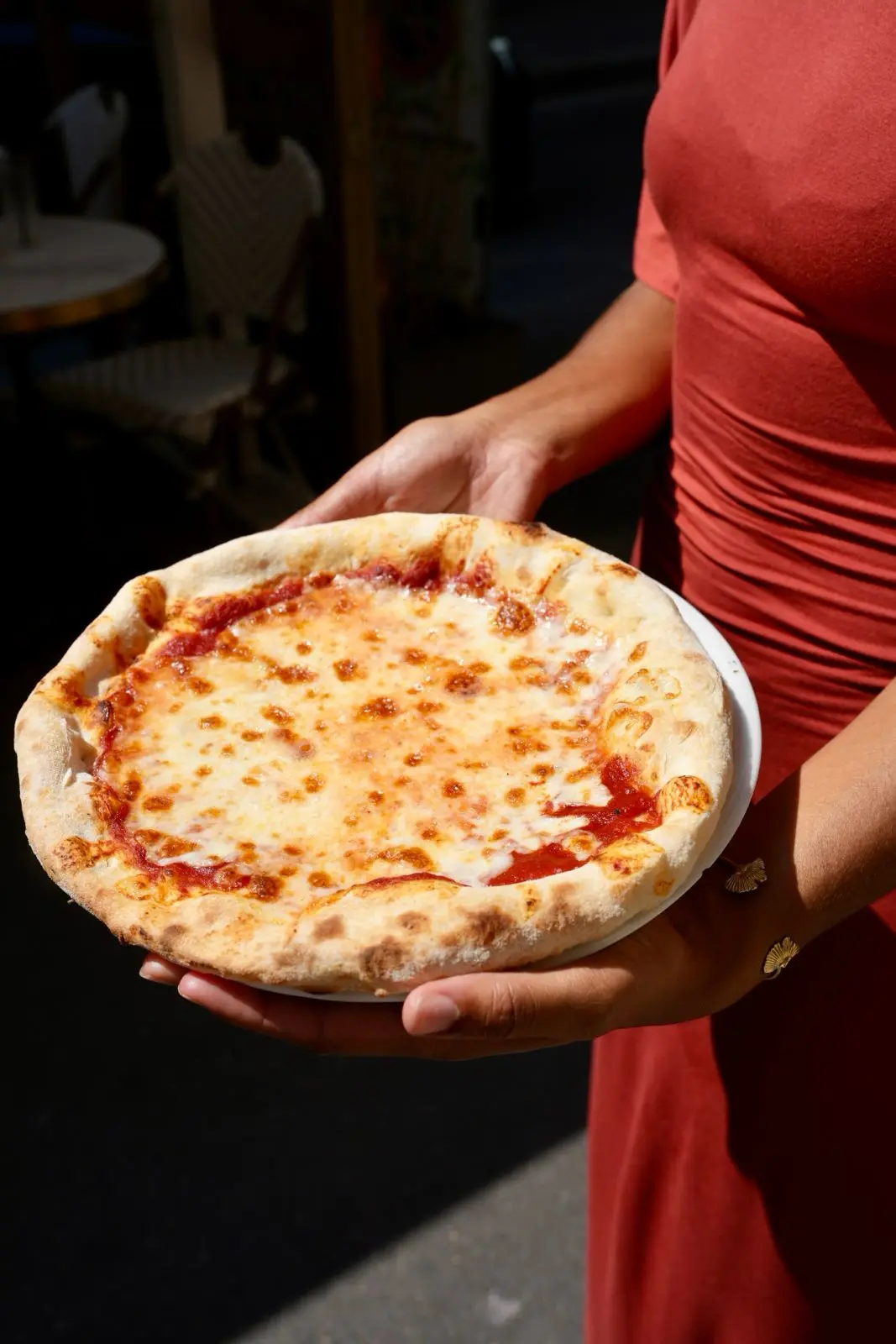 A cheese pizza served in full sun