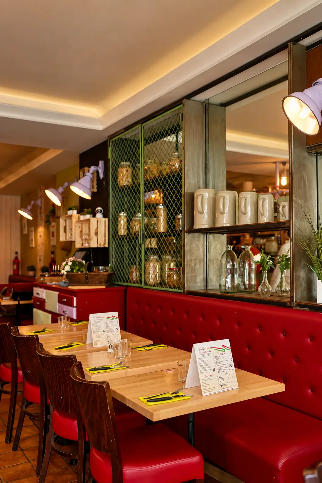 Tables lined up along the red banquette